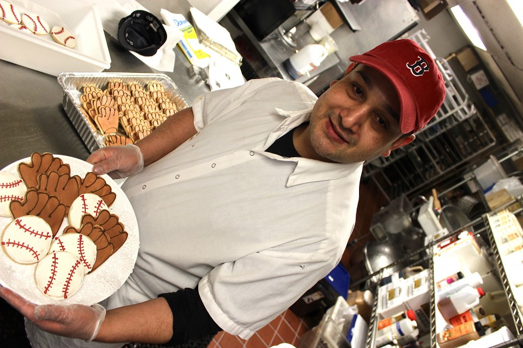 Jules' resident "Cookie Monster" Wilmar Aristizabal offers a few of the 1,500 cookies he baked for the Red Sox home opener